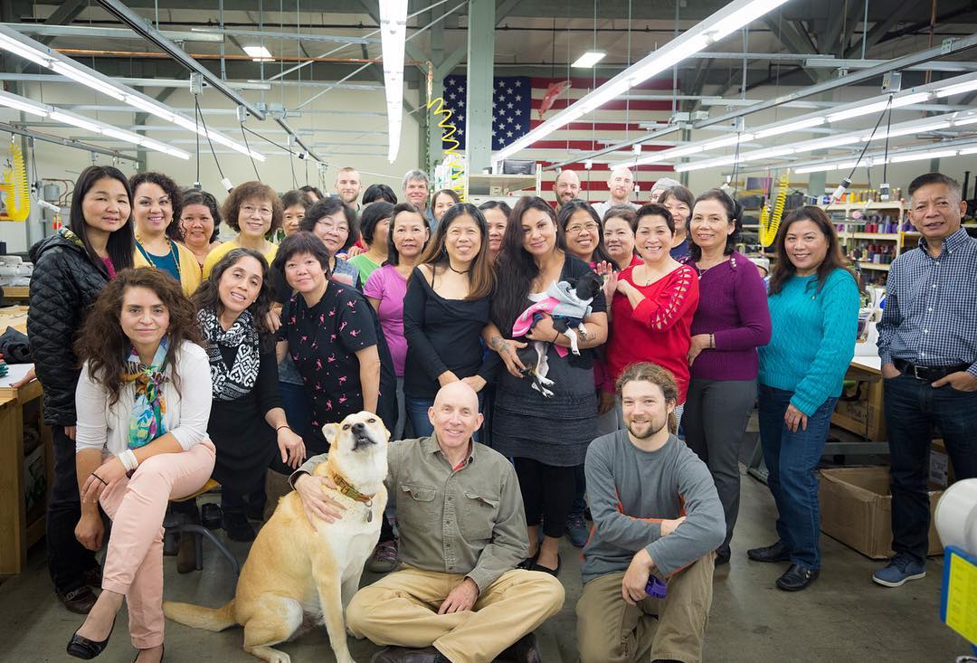 A group photo of the TOM BIHN crew inside the factory, along with Ichiro the dog.