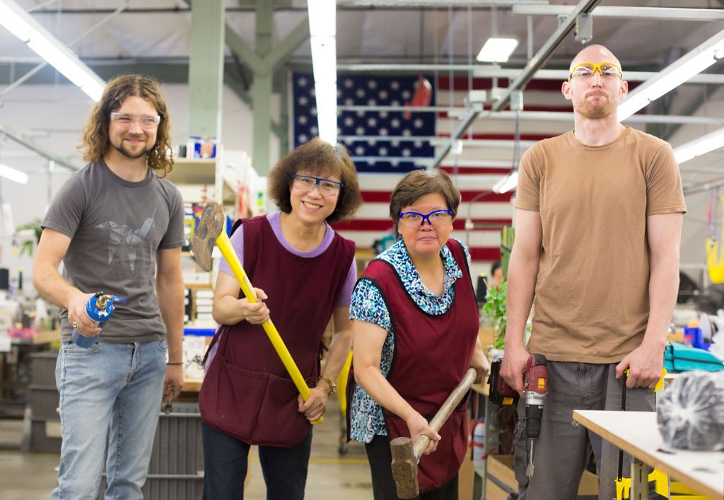 Nik, Lisa, Fong, and Ben: everyone's holding tools like they're about to demolish the old showroom! 
