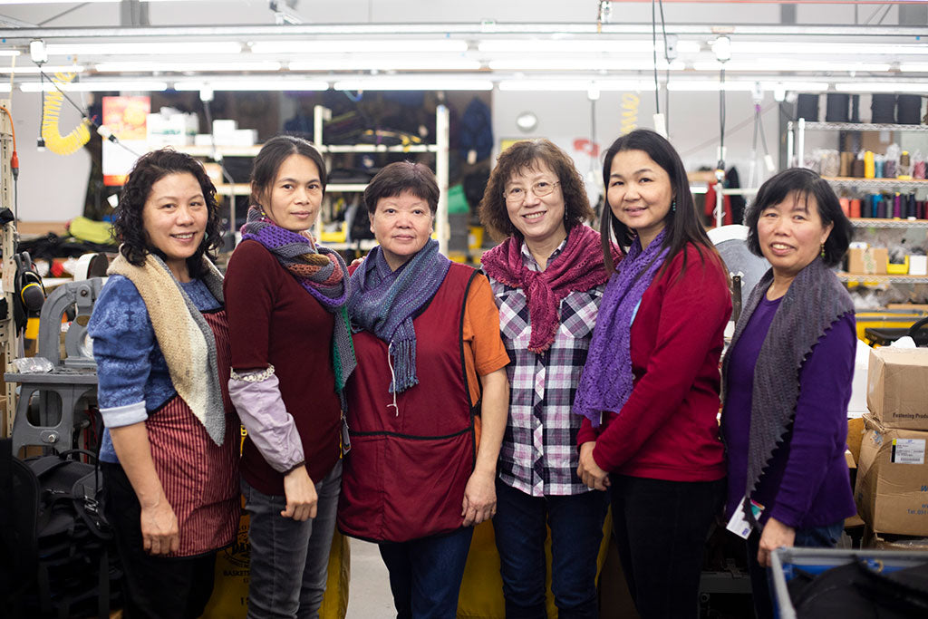 Juanna, Mei, Fong, Lisa, Zhong, and Ying all wearing scarves knitted by the TOM BIHN Ravelry group.