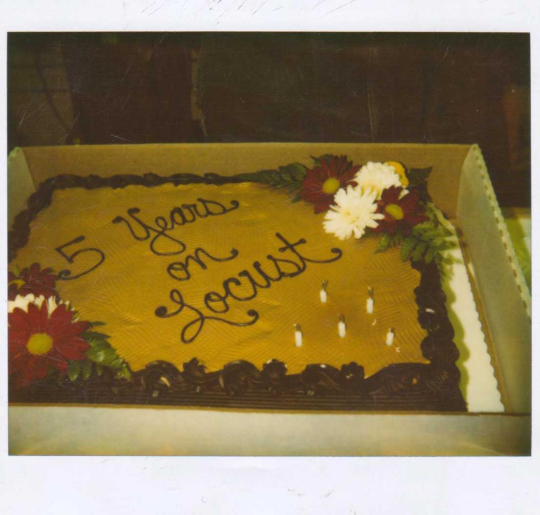 A really yummy looking cake that Tom's mom Bobbie brought to celebrate the anniversary of his shop: it has flowers and yellow and brown frosting.