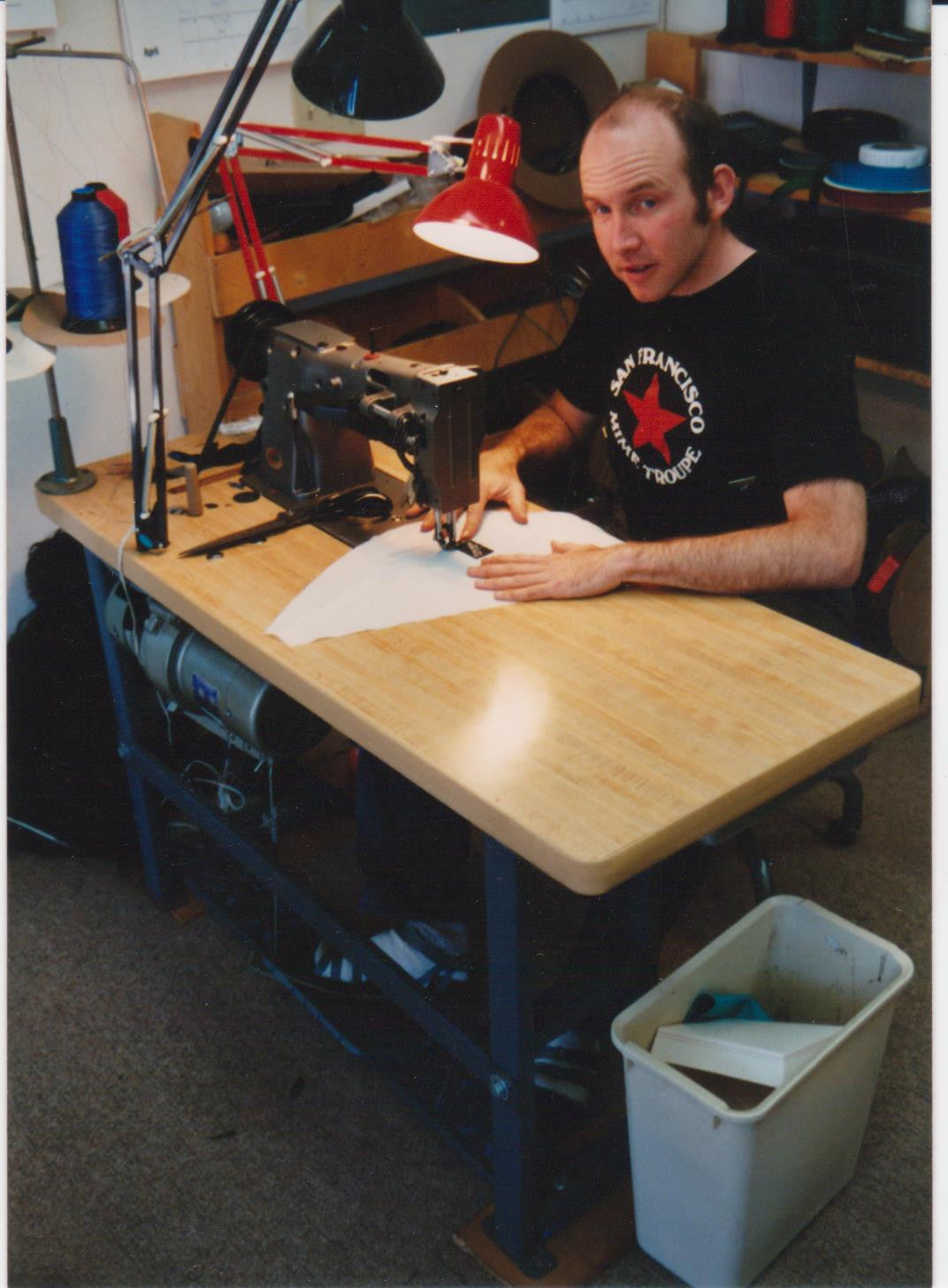 Tom sewing at his first shop!