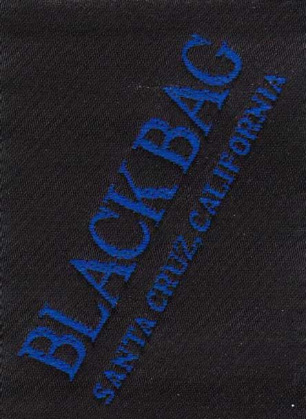 The Black Bag label has a black background; the text is bright blue and says "Black Bag Santa Cruz California"