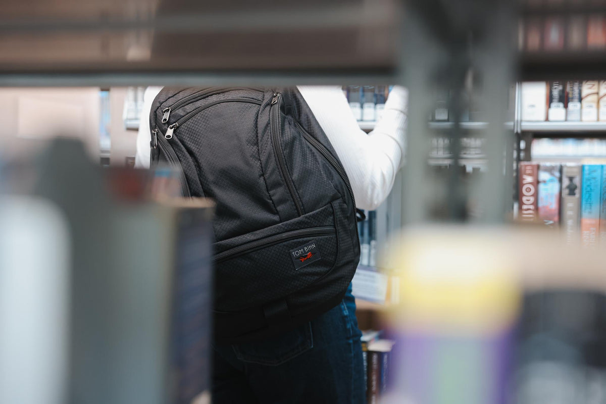 visible lifestyle^^A person wearing a Spectron Synik 26 in a library