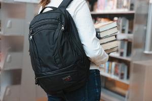 visible lifestyle^^A person wearing a Spectron Synik 26 in a library