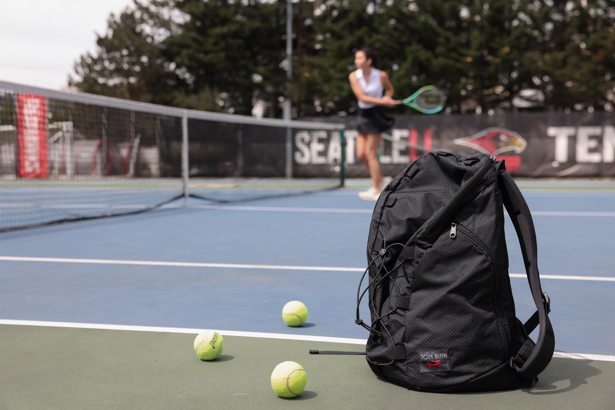 visible lifestyle^^A Smart Alec 2.0 in the foreground while a person plays tennis in the background.