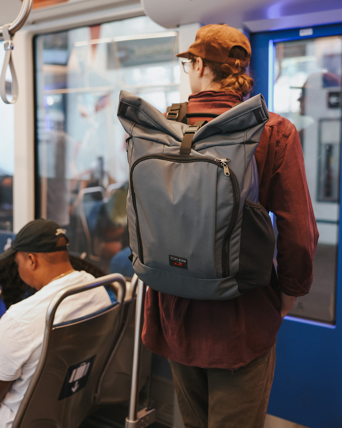 visible lifestyle^^A person riding in a light rail car wearing the Adept