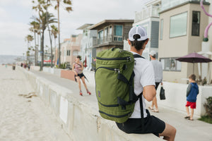 lifestyle visible^^Person carrying an Aeronaut 45 sitting on the wall at the Venice Beach, CA boardwalk.