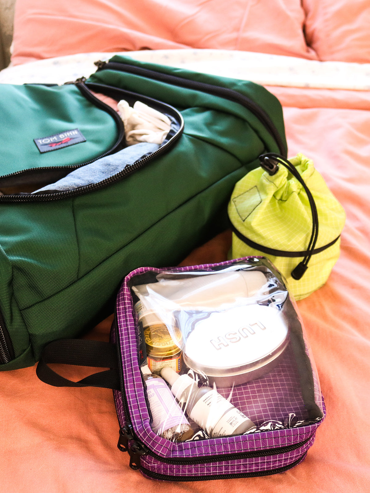 visible lifestyle^^Double Clear Organizer Cube with toiletries in it beside a Small Travel Tray and Aeronaut 30