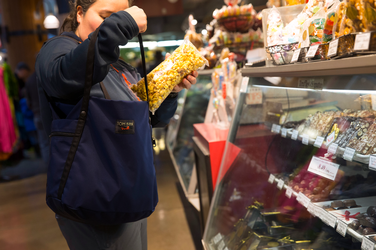 visible lifestyle^^ Person putting popcorn in Pop Tote.