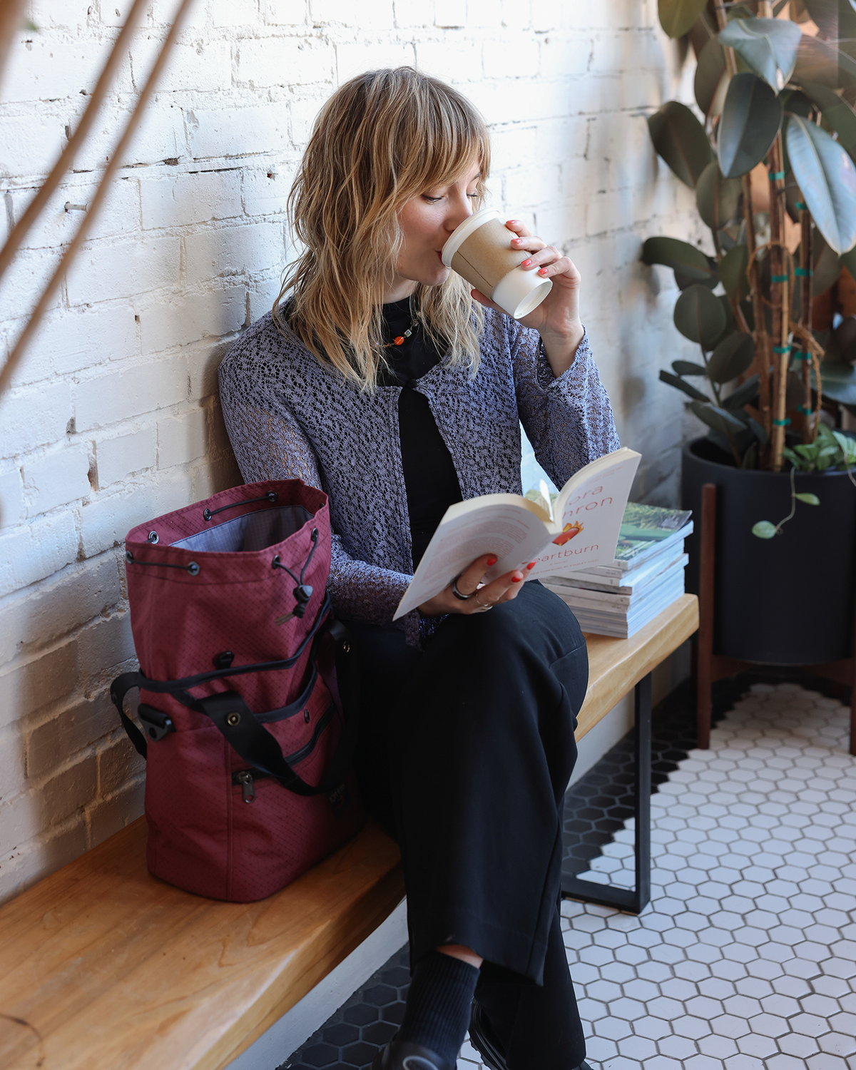 visible lifestyle^^A person sitting at a cafe next to the Forager.