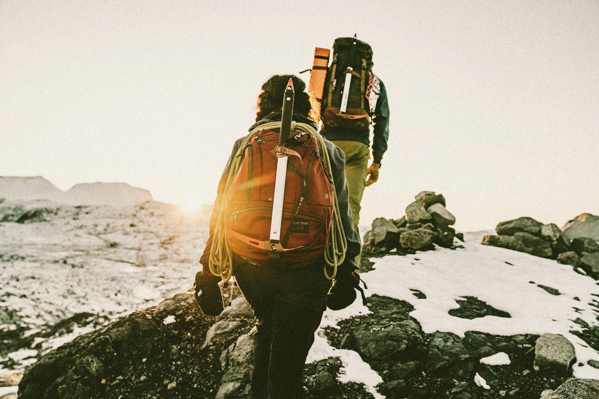 lifestyle visible^^Person hiking with ice pick attached to lash strap of Guide's Edition Synik 30.