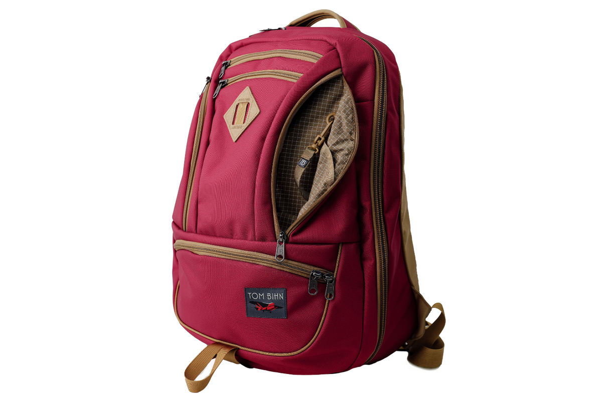 visible variant TB0183-PKCD^^The Guide's Edition Synik 30 in Raspberry 630 Ballistic. Reddish pink backpack with gold accents on a white background