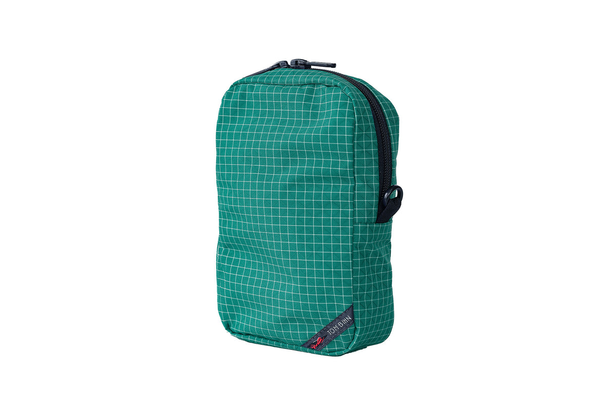 visible variant TB0912-ED^^ Green grid-patterned pouch with a brand logo on a white background