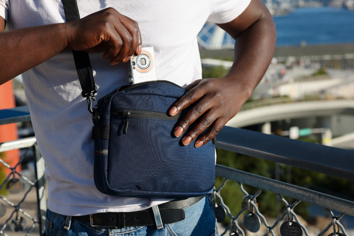lifestyle visible^^Person pulling camera out of the main compartment of the Side Kick.
