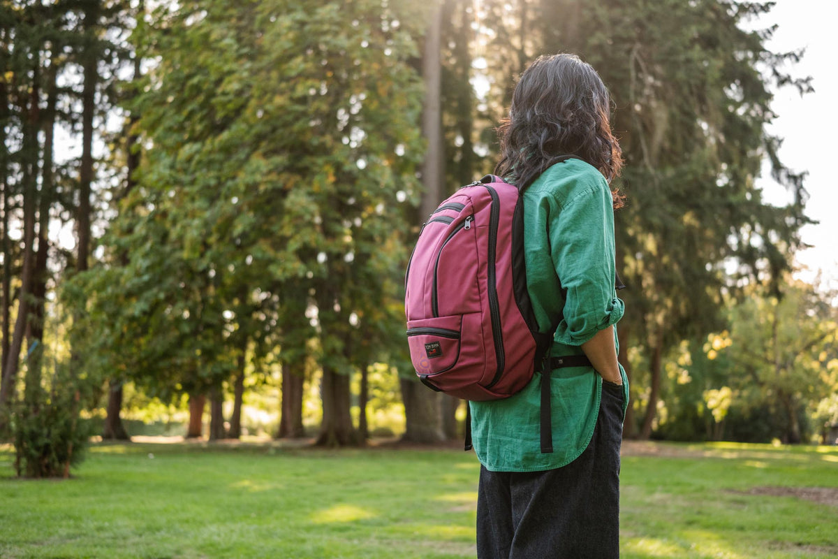A person wearing a Synik 26 in a wooded area