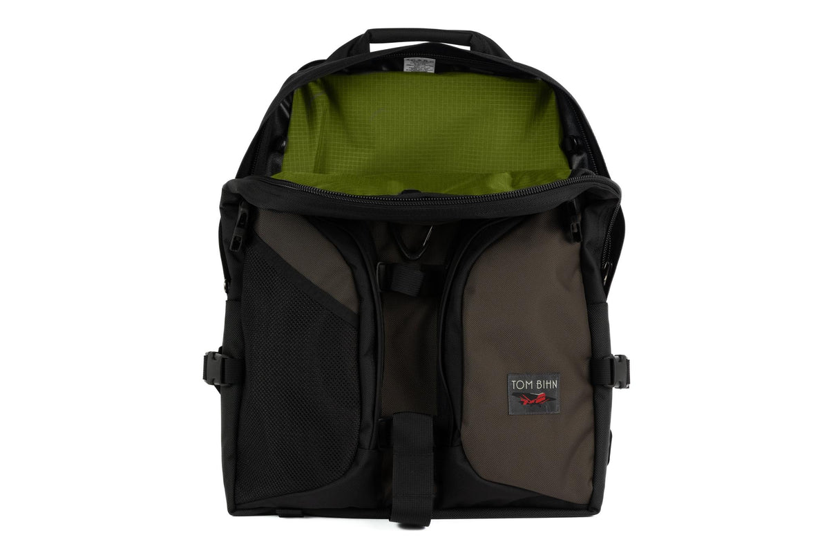 visible variant TB0114-RKML^^The Brain Bag in Ursa (brown-grey) Ballistic with the front main compartment zipper opened to reveal its Moss (dark green with green grid) 210 Cerylon interior.