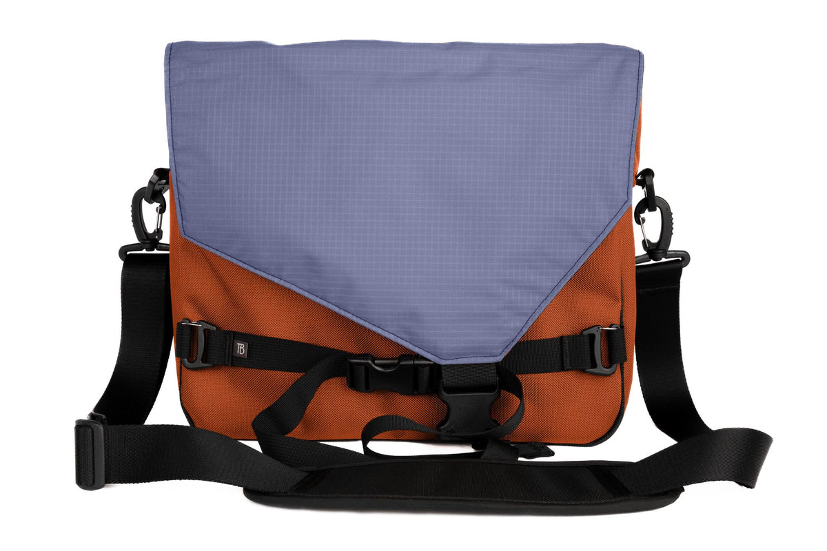 visible variant TB0204-TKDL^^The Maker's Bag in Burnt Orange Ballistic with a Dusk (bluish-purple with light bluish-purple grid) 210 Cerylon interior.