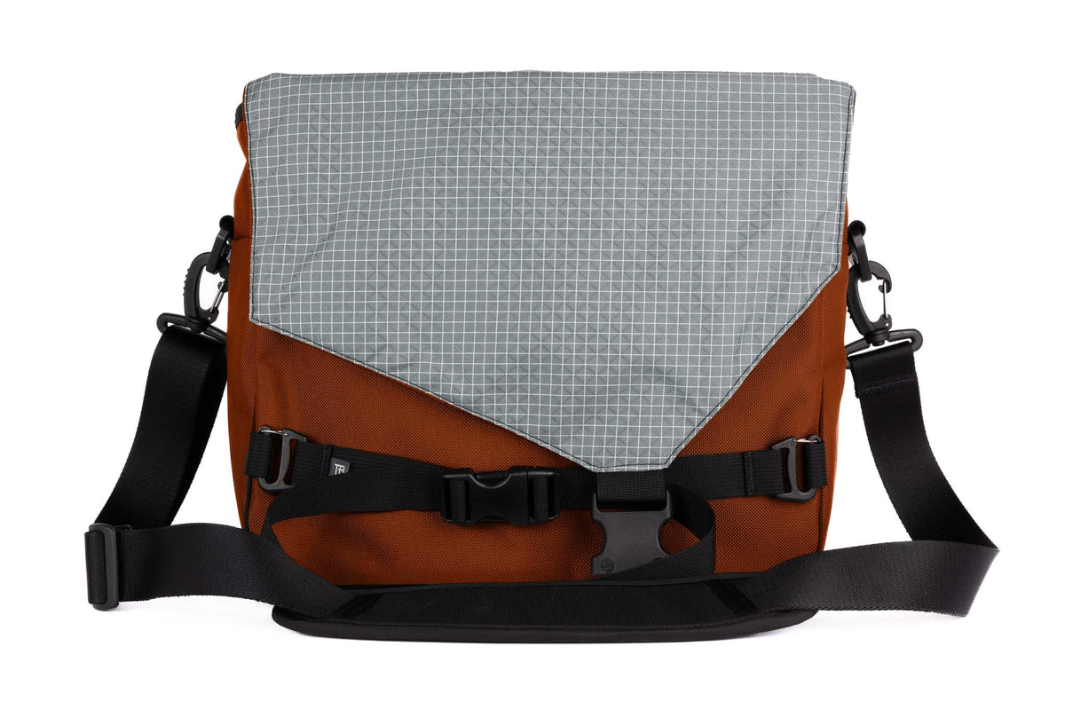 visible variant TB0204-TKND^^The Maker's Bag in Burnt Orange 525 Ballistic with a Northwest Sky (light grey with white grid) 200 Halcyon interior.