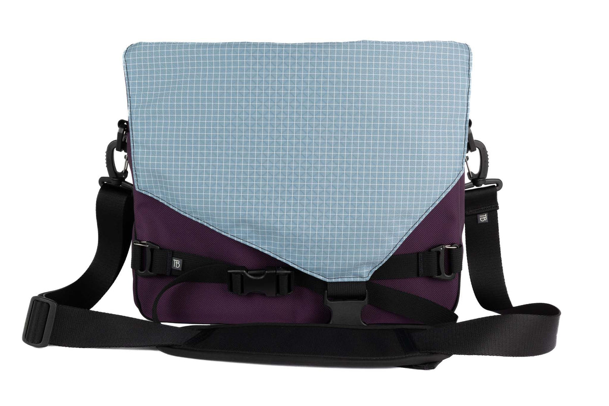 visible variant TB0204-UK7D^^The Maker's Bag in Aubergine (dark purple) Ballistic with Tidal (faded blue with white grid) 200 Halcyon interior.