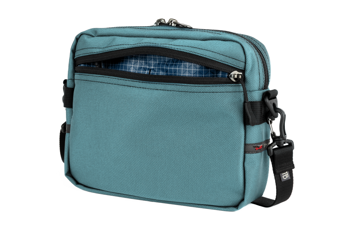 visible variant TB0414-KKFD^^The Side Kick in Agave Ballistic with a Fjord (dark blue with white grid) 200 Halcyon interior.