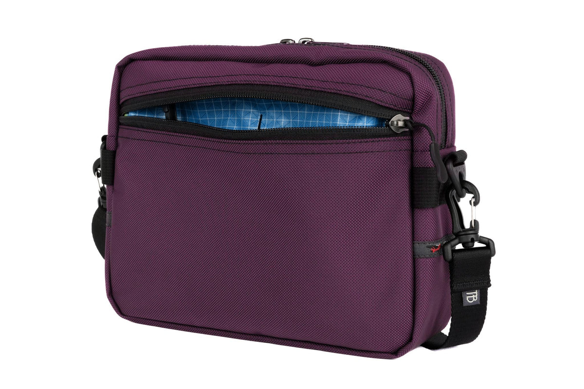 visible variant TB0414-UKLD^^The Side Kick in Aubergine (dark purple) Ballistic with a Island (blue with white grid) 200 Halcyon interior.
