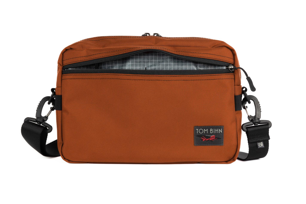 visible variant TB0415-TKND^^The Side Hustle in Burnt Orange Ballistic with Northwest Sky (grey) 200 Halcyon interior.