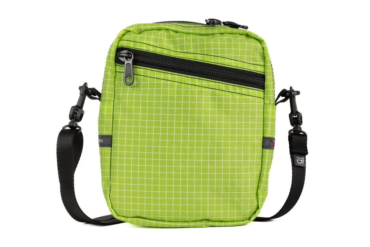 visible variant TB0416-1DGE^^Front photo of an Everyday Cubelet in Kiwi Halcyon (bright green with a white grid) with a front zipper.