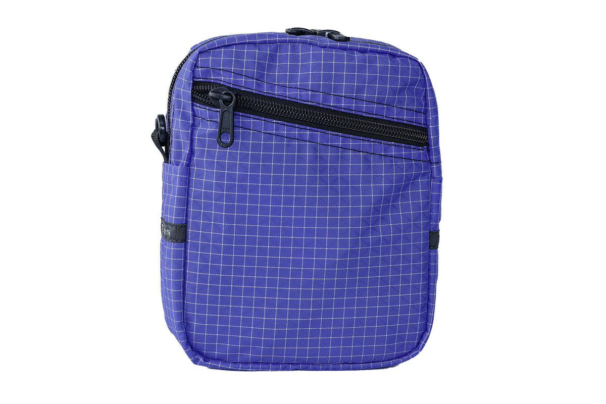 visible variant TB0416-9DGE^^An Everyday Cubelet in Selkie Halcyon (purplish-blue with a white grid) with a front zipper.