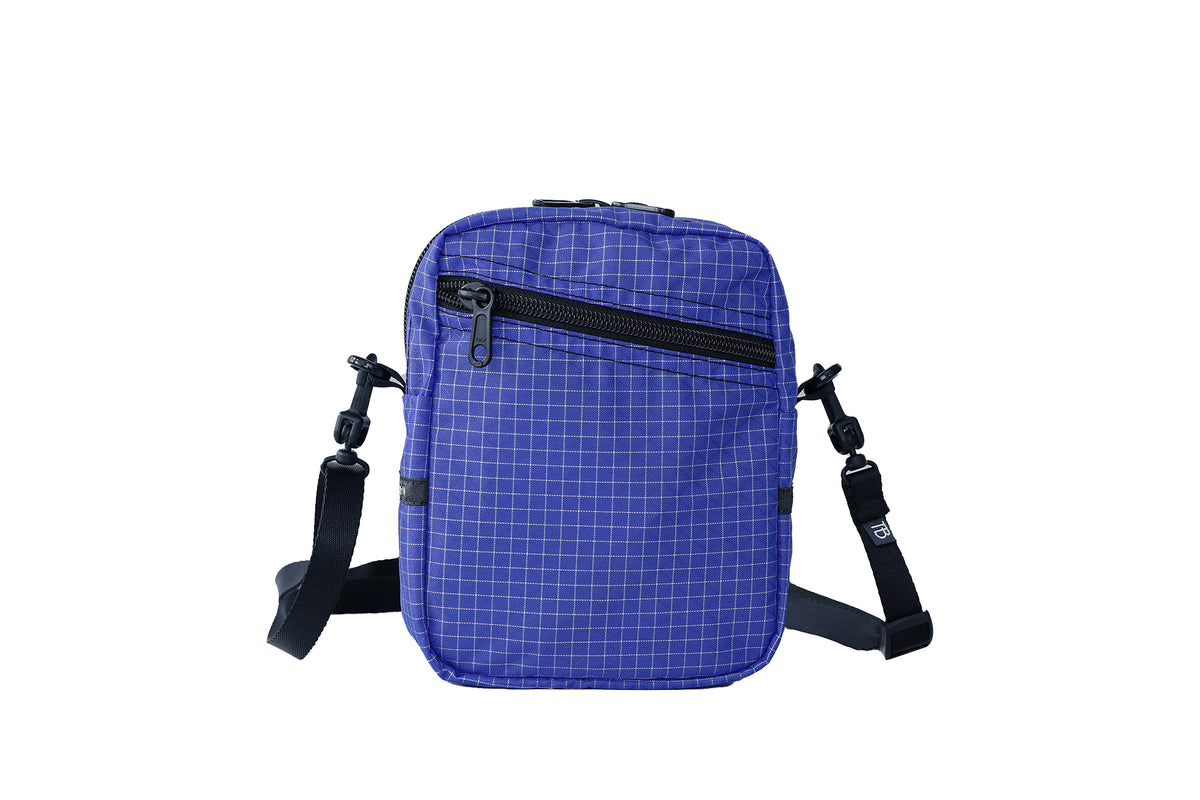 visible variant TB0416-9DGE^^An Everyday Cubelet in Selkie Halcyon (purplish-blue with a white grid) with a front zipper.