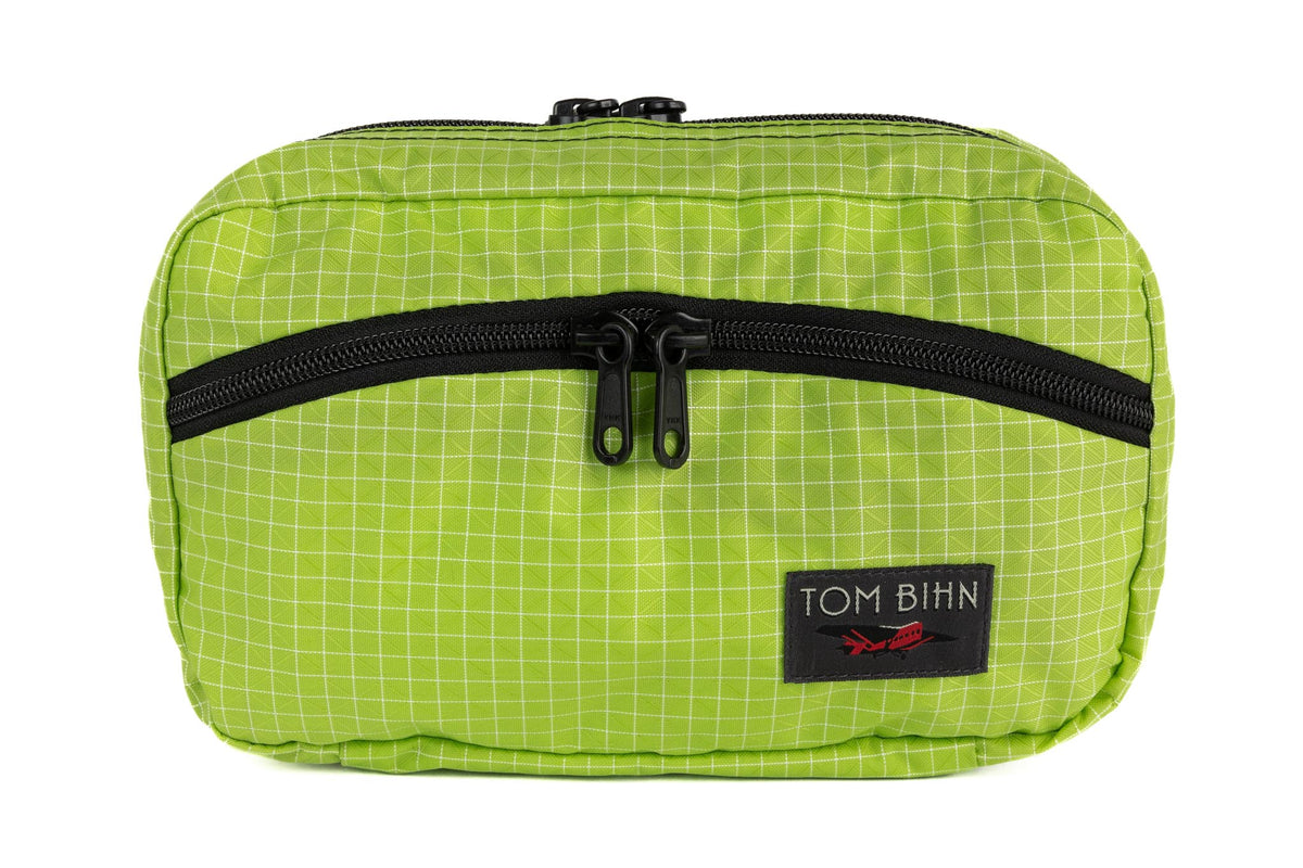 visible variant TB0419-1D^^The rear of a Handy Little Thing #2 in Kiwi (bright green with white grid) 200 Halcyon showing the front zipper with two slider and logo at the bottom-right corner.