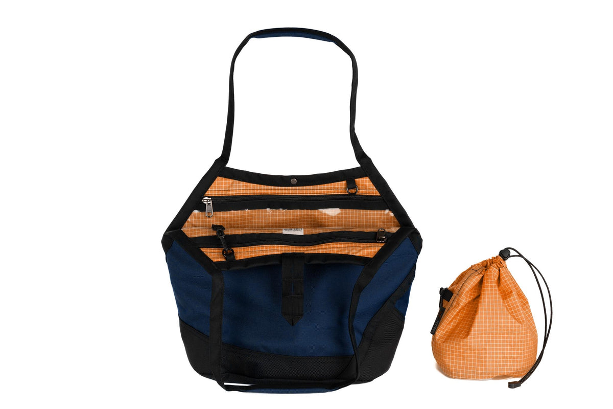 visible variant TB0660-DKZD^^A Swift in Deep Blue (dark blue) Ballistic with Zest (orange with white grid) 200 Halcyon interior and Yarn Stuff Sack.