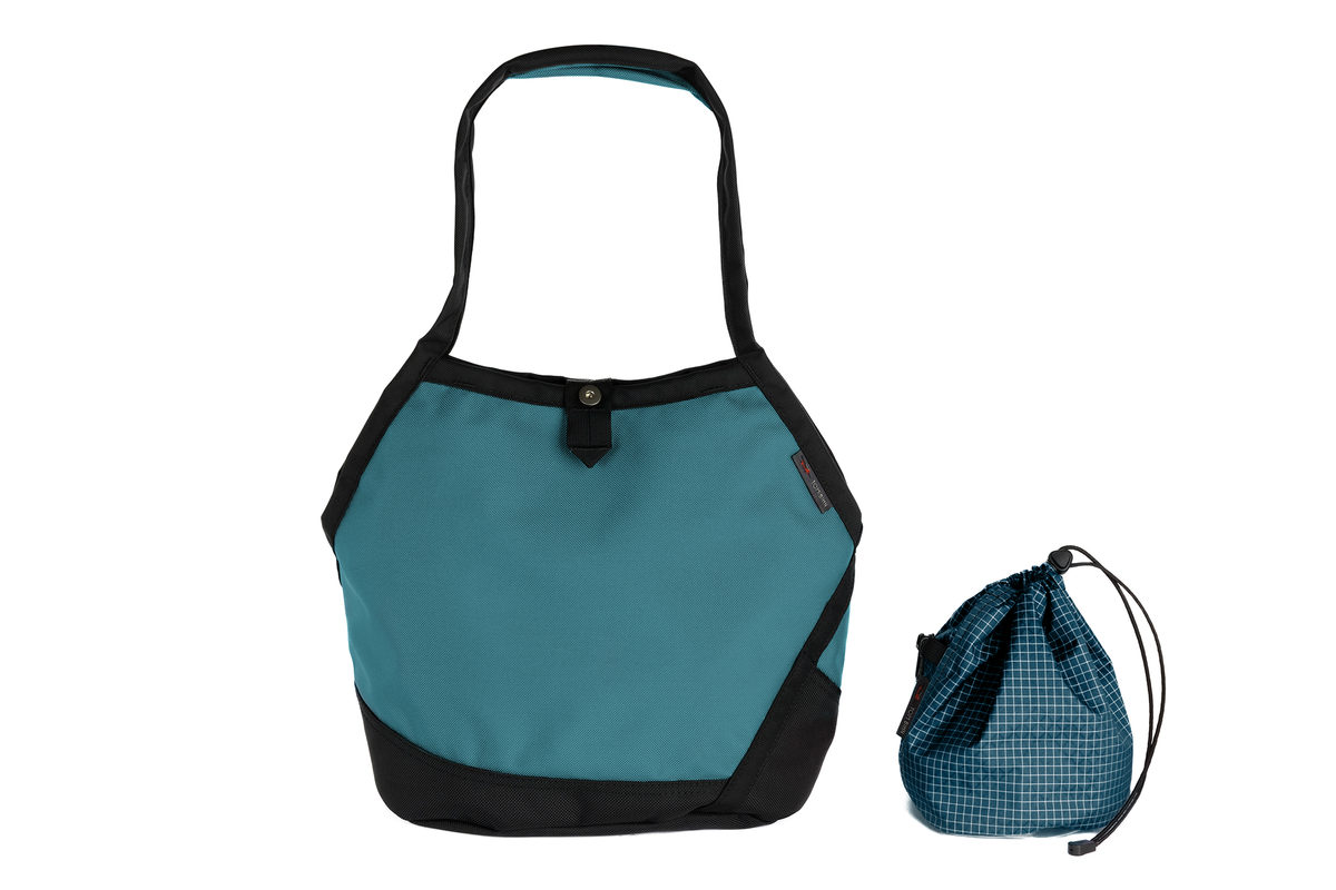 visible variant TB0660-KKFD^^A Swift in Agave Ballistic with Fjord (dark blue with white grid) 200 Halcyon interior and Yarn Stuff Sack.