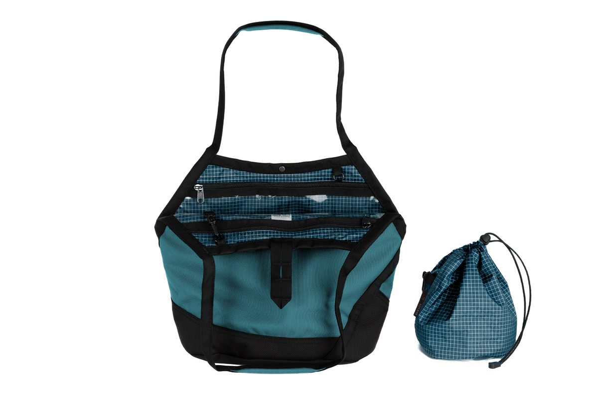 visible variant TB0660-KKFD^^A Swift in Agave Ballistic with Fjord (dark blue with white grid) 200 Halcyon interior and Yarn Stuff Sack.