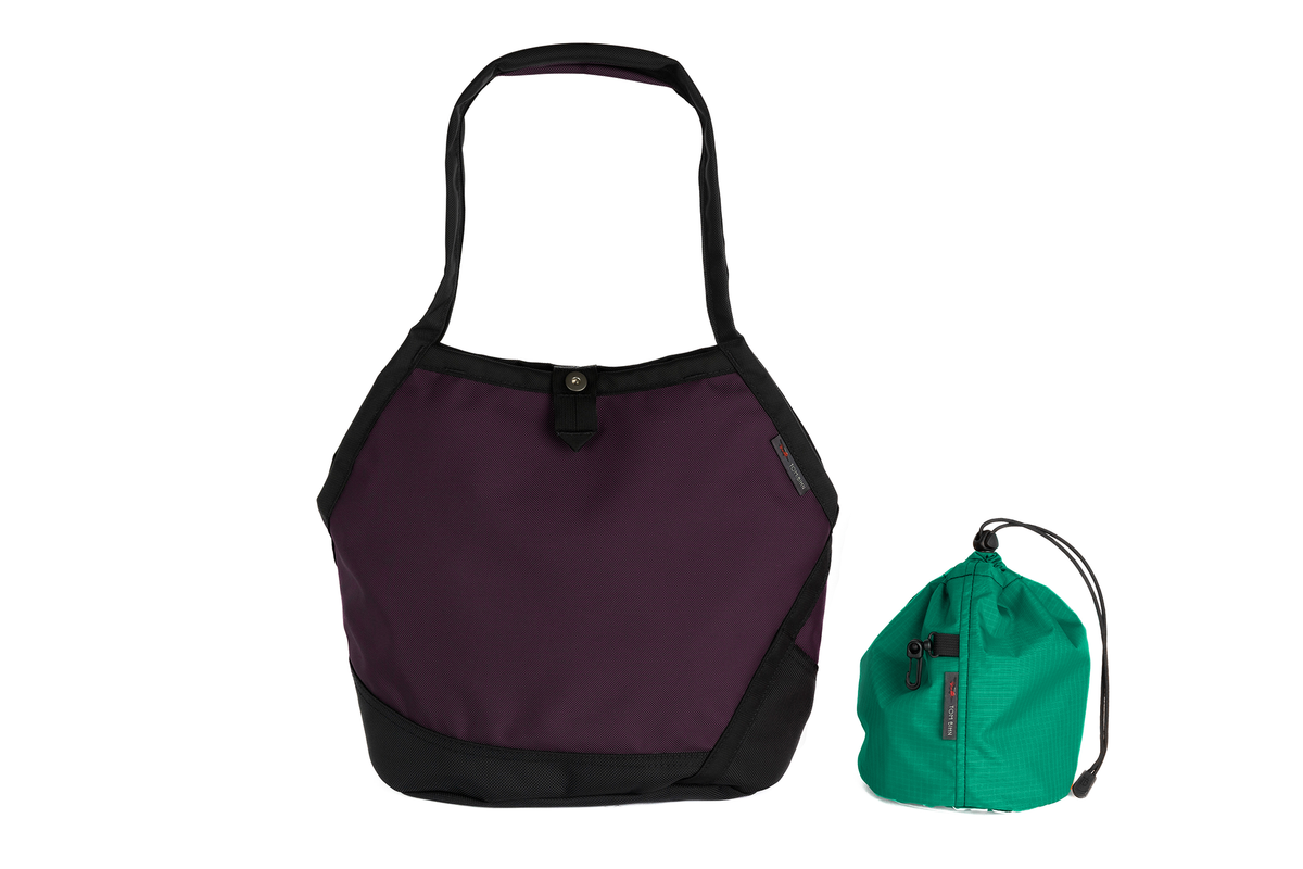 visible variant TB0660-UKEL^^The Swift in Aubergine Ballistic with a Emerald (green with dark green grid) interior and Medium Yarn Stuff Sack