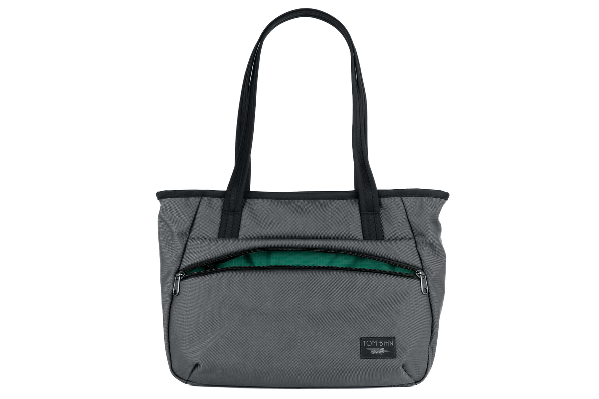 visible variant TB0715-GKEL^^Photo of the Nomad Tote in Nebulous Grey Ballistic with Emerald (green with light green grid) 200 Halcyon interior.