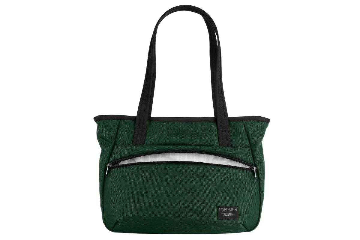 visible variant TB0715-WKTD^^Photo of the Nomad Tote in Wilderness Ballistic with Tahoma (white with white grid) 200 Halcyon interior.
