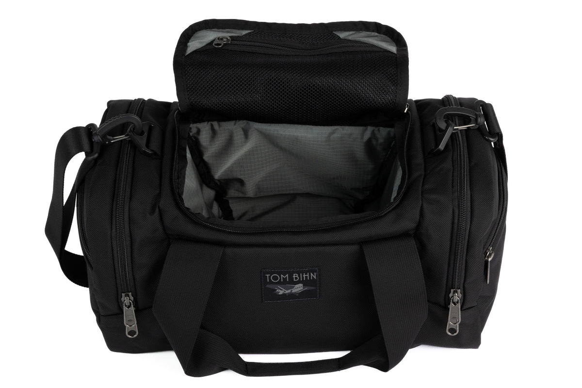 visible variant TB0904-BKGL^^The Night Flight Travel Duffel in Black Ballistic with a Mountain Grey 210 Cerylon interior.