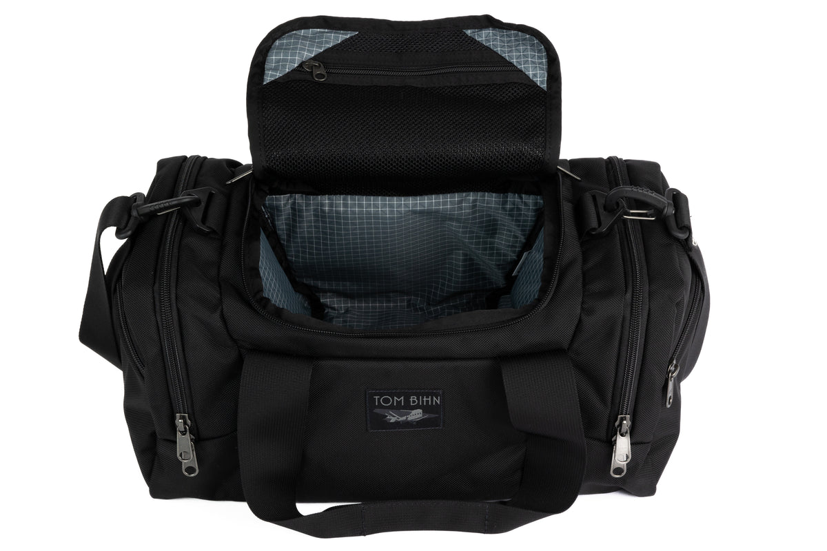 visible variant TB0904-BKND^^The Night Flight Travel Duffel in Black Ballistic with a Northwest Sky 210 Cerylon interior.