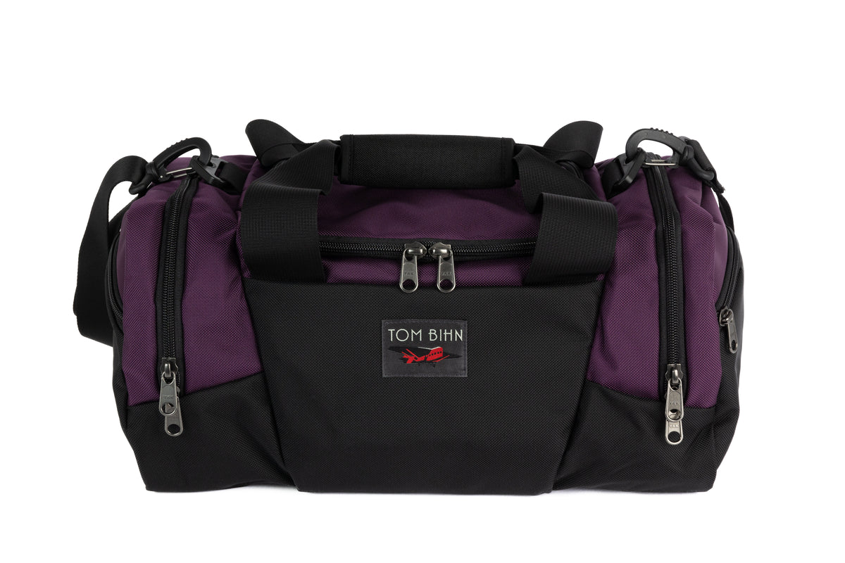 visible variant TB0904-UK9D TB0904-UK7D TB0904-UK5D TB0904-UKGD TB0904-UKWD TB0904-UKDL^^The Night Flight Travel Duffel in Aubergine Ballistic.
