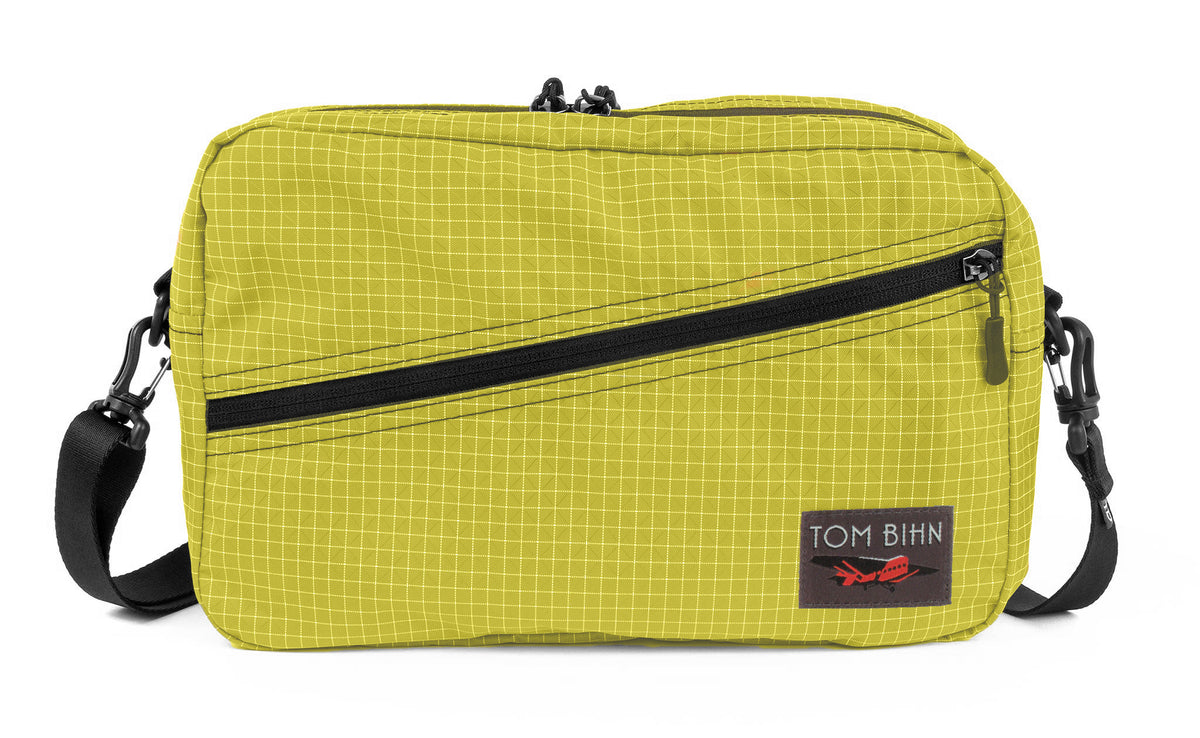 visible variant TB0921-WD^^A Packing Cube Shoulder Bag in Wasabi (green with white grid) 200 Halcyon with a shoulder strap.