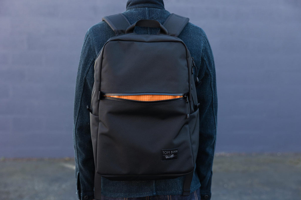 visible lifestyle^^Paragon with front pocket open, bright orange interior