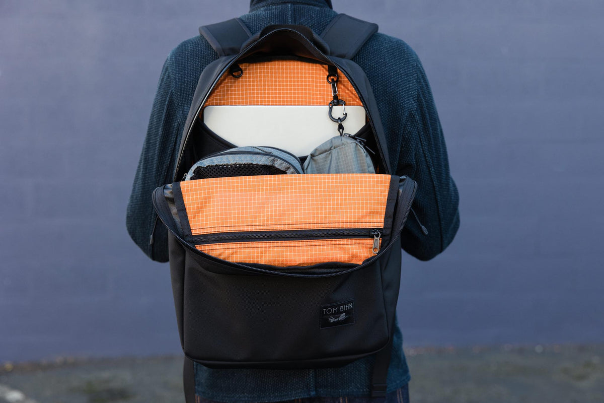 visible lifestyle^^An open backpack with bright orange interior
