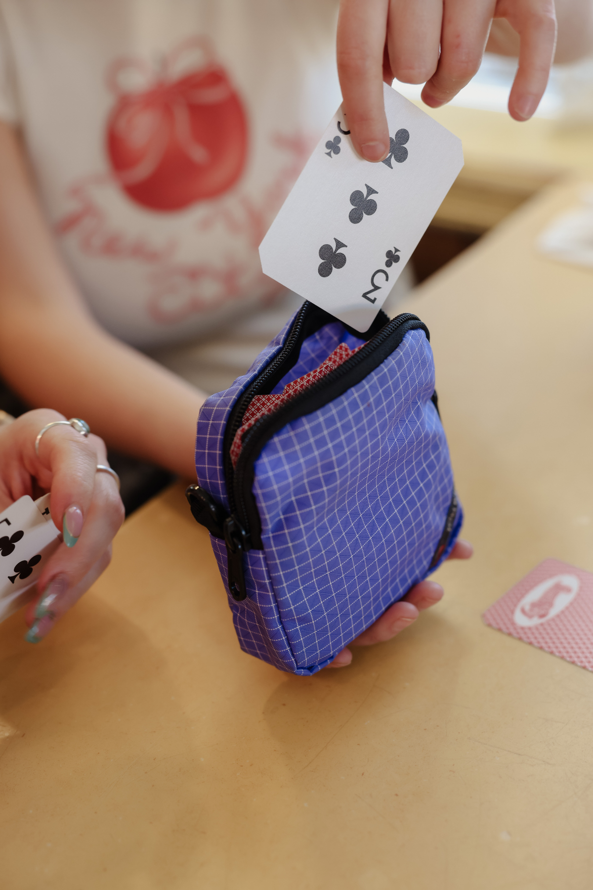 lifestyle visible^^Cubelet in Selkie Halcyon with playing cards being placed inside.