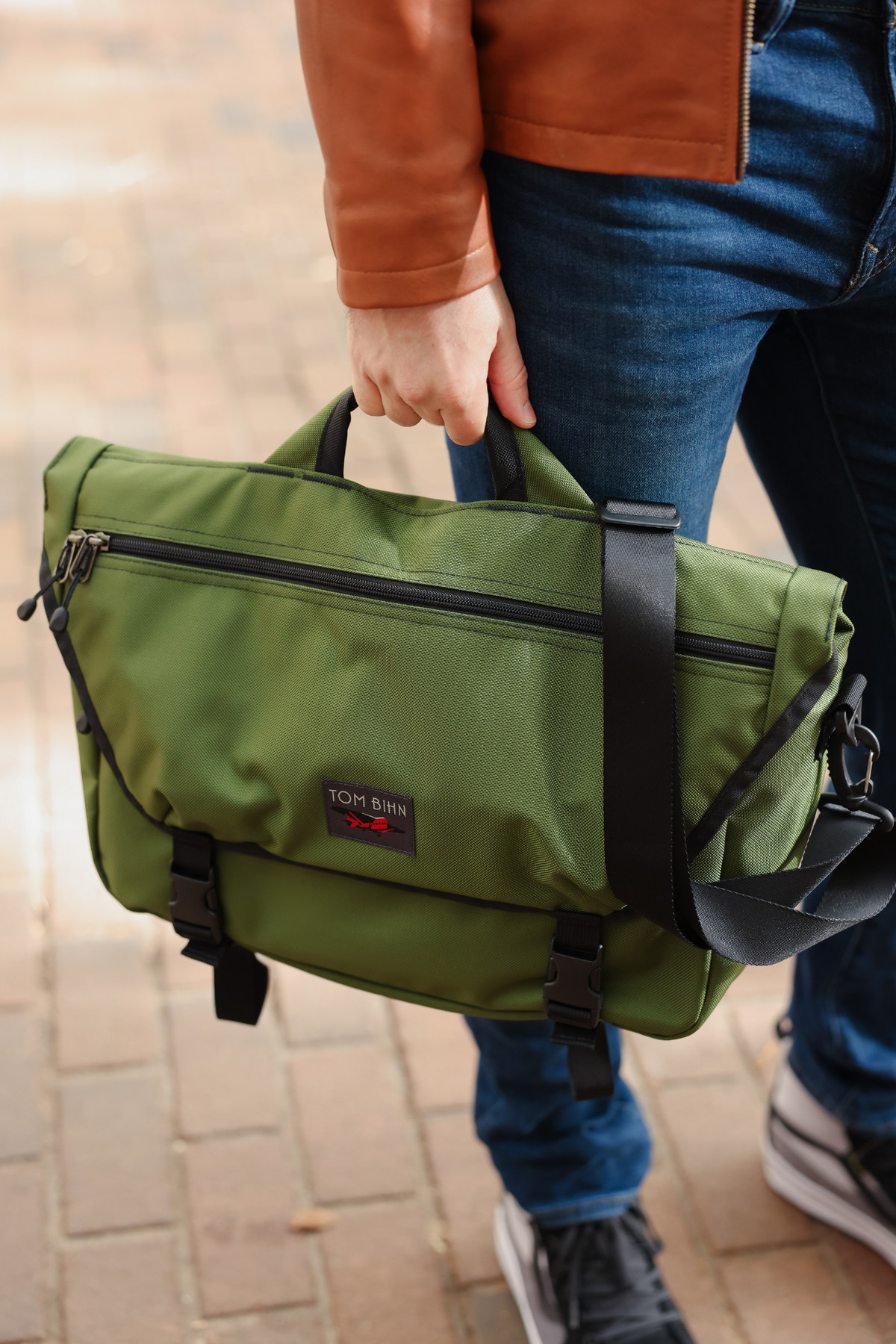 lifestyle visible^^Marathon Messenger in Saguaro Ballistic held via grab handle.