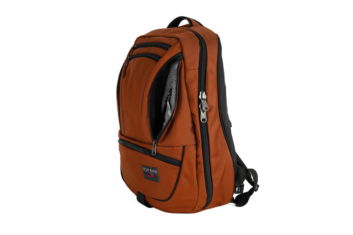 visible variant TB0121-TKND^^The Synik 30 in Burnt Orange 525 Ballistic with a Northwest Sky (light grey with white grid) 200 Halcyon interior.