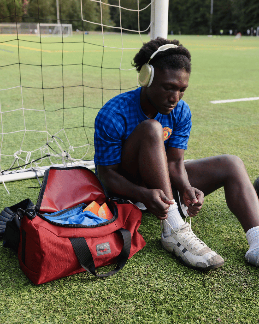 lifestyle visible^^A person sitting by a packed Small Yeoman Duffel.