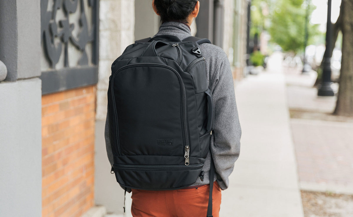 A person walking wearing the Techonaut 30 as a backpack.