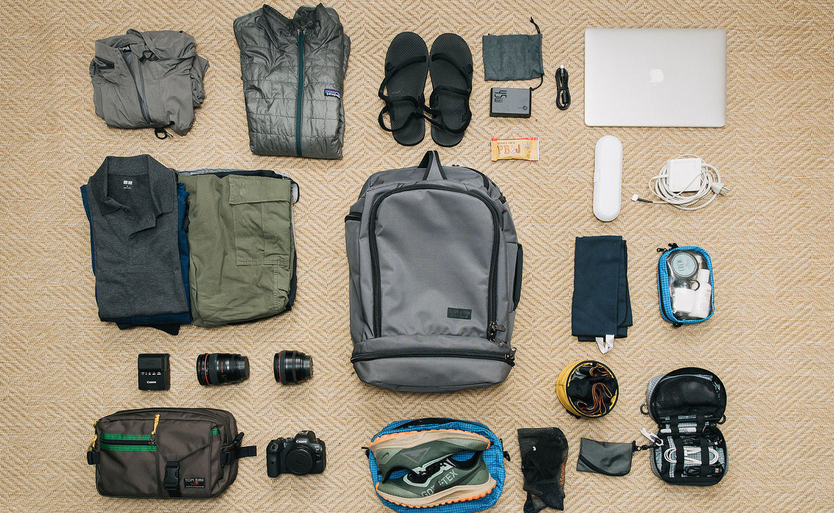 Techonaut 45, including clothing, toiletries, shoes, laptop, and a camera bag.