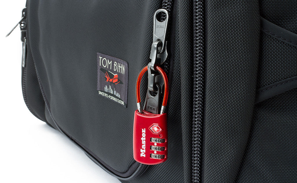 A standard TSA-compliant lock fits through the rings in the locking zipper.