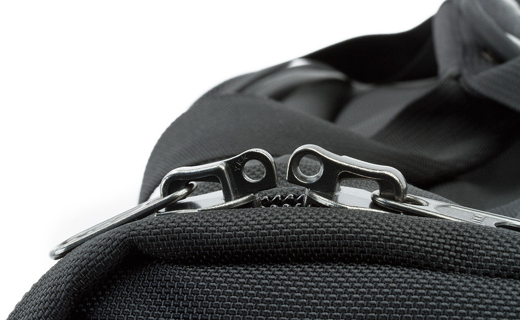Each of the side pockets and the main pocket have two zipper pulls that come together with rings at the end that a luggage lock can be slipped through to keep your bag locked closed.
